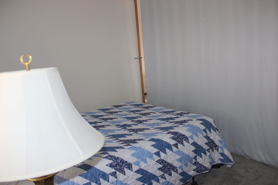 Queen bed with privacy curtain pulled