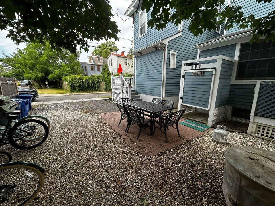 Private patio with table and grill in the back.