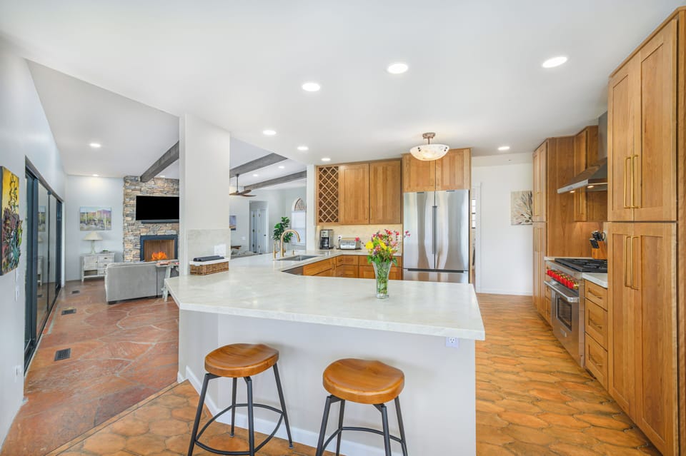 Stainless steel appliances and view into living room from kitchen