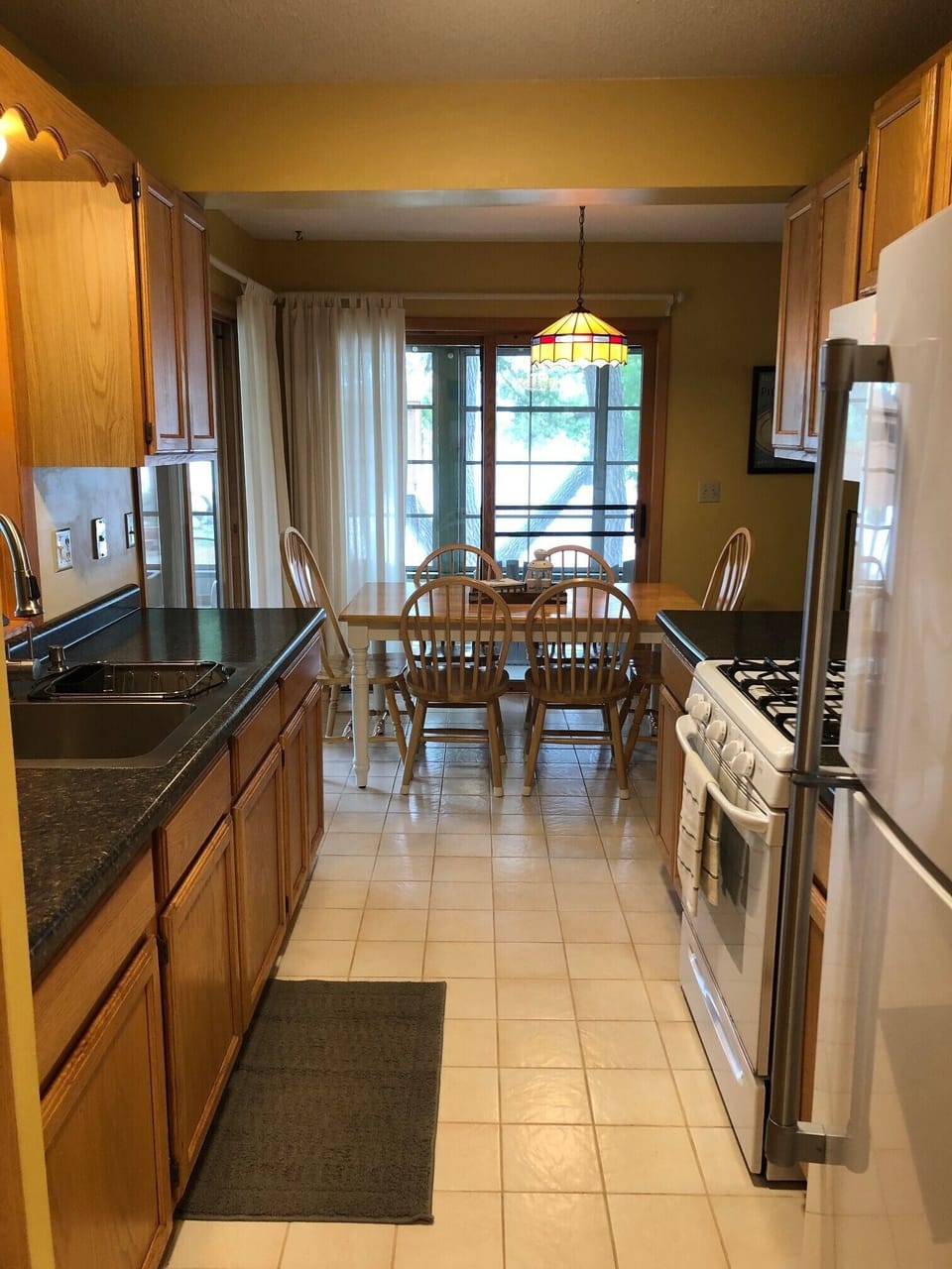 Well stocked kitchen with new counter tops and lighting.