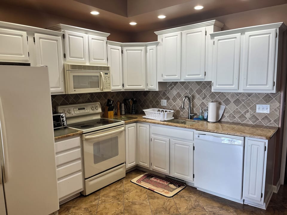 Kitchen fully loaded with utensils, Dishes,, pots, pans, and glasses