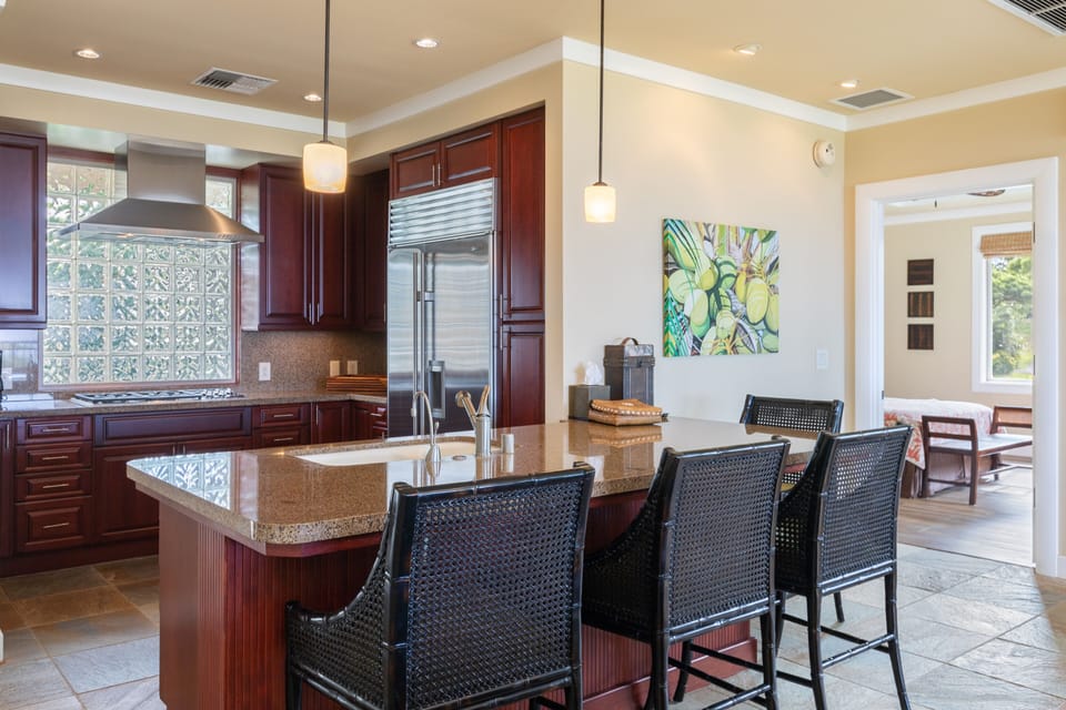 Chef's open kitchen with additional counter seating 