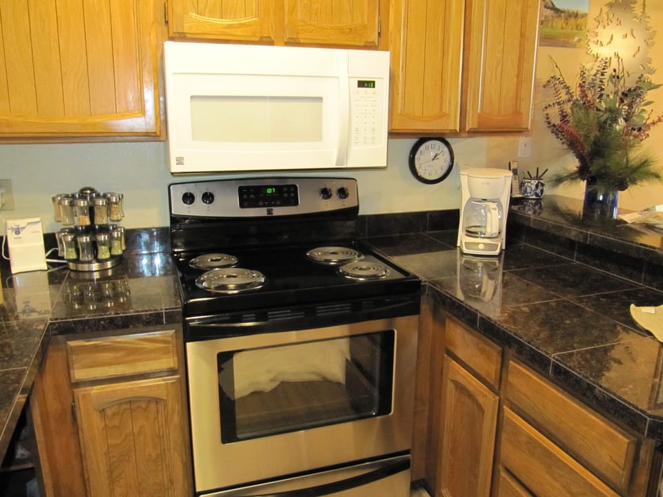 Kitchen is fully stocked with pots, pans, plates, etc.