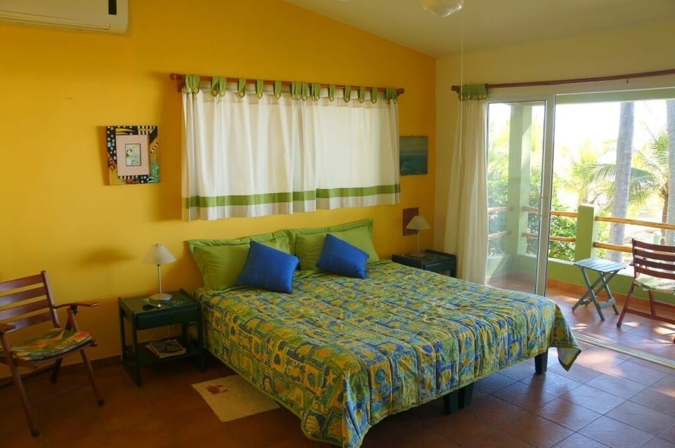 Master bedroom upstairs. 1 kingsize bed. a/c, porch to watch the sunsets from.