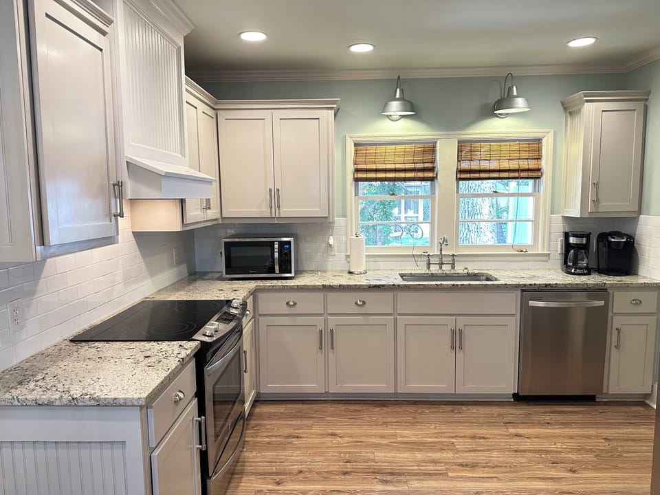 Stainless steel appliances with glass top range and microwave.  