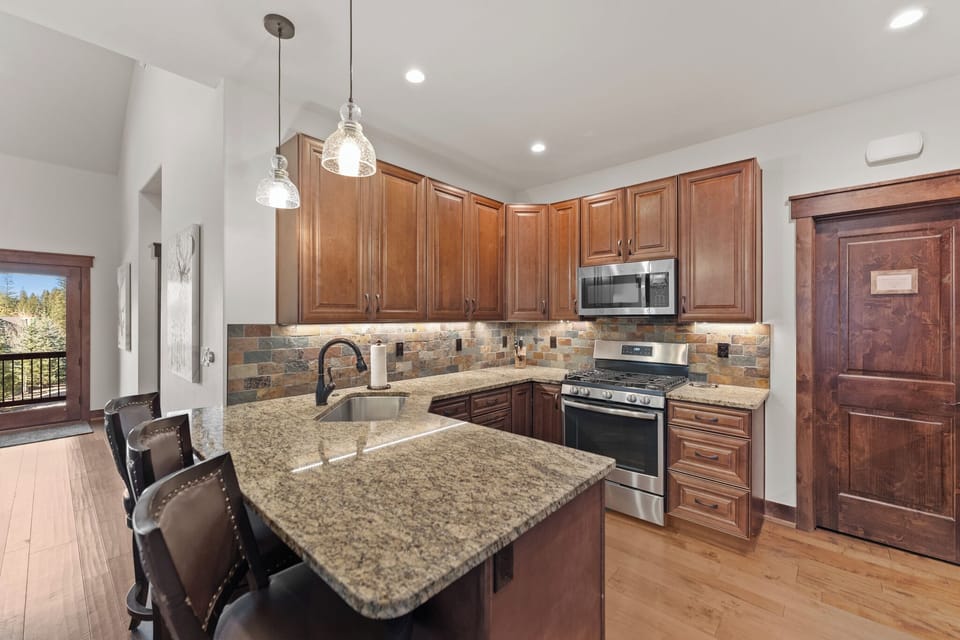 Your fully equipped kitchen features rich wood cabinets, granite countertops, and modern appliances where you'll love preparing meals.