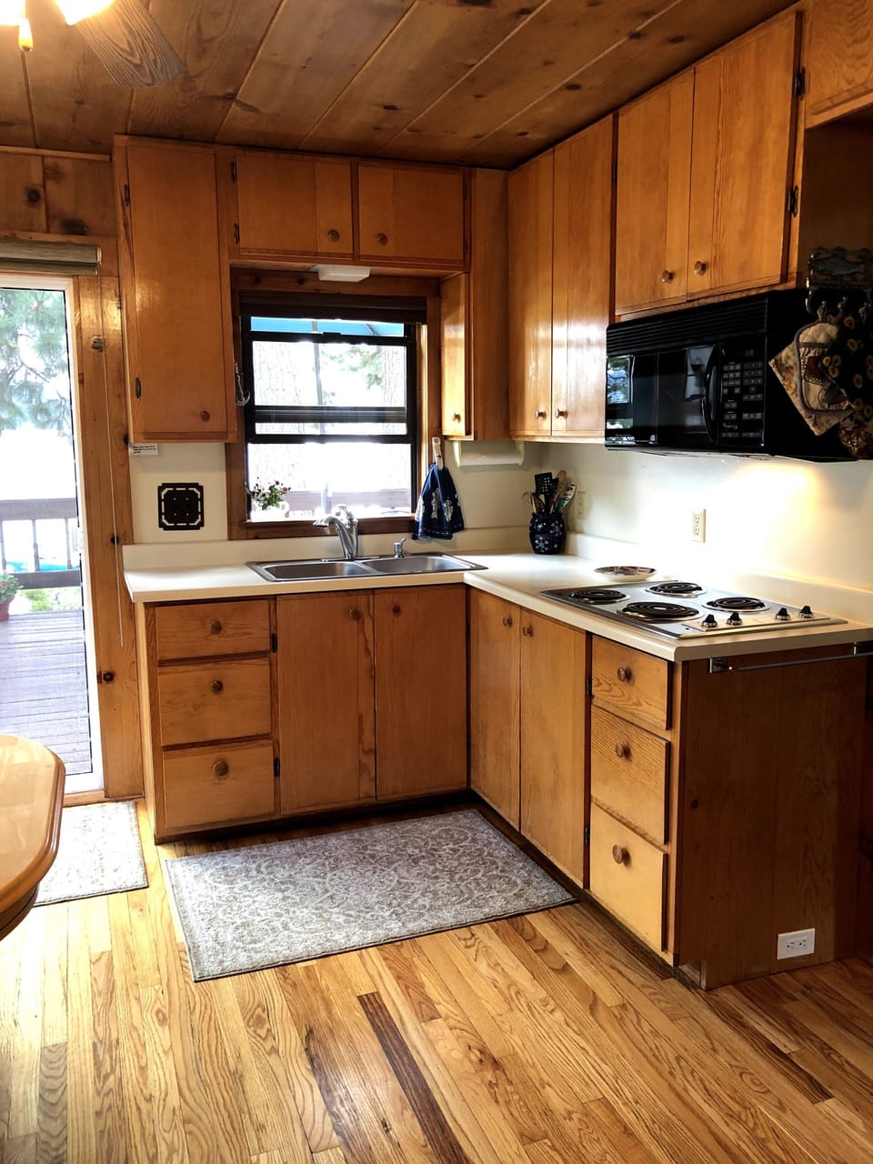 Cupboards are filled with pots, pans, casserole dishes & cooking supplies