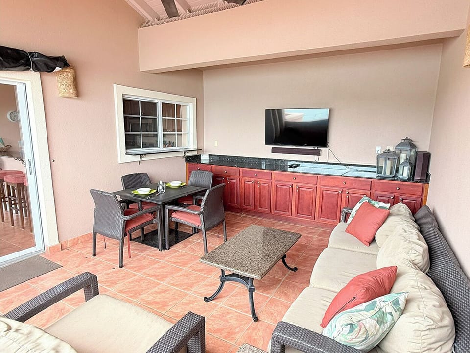 Your covered outdoor living & dining area is cozy and comfortable