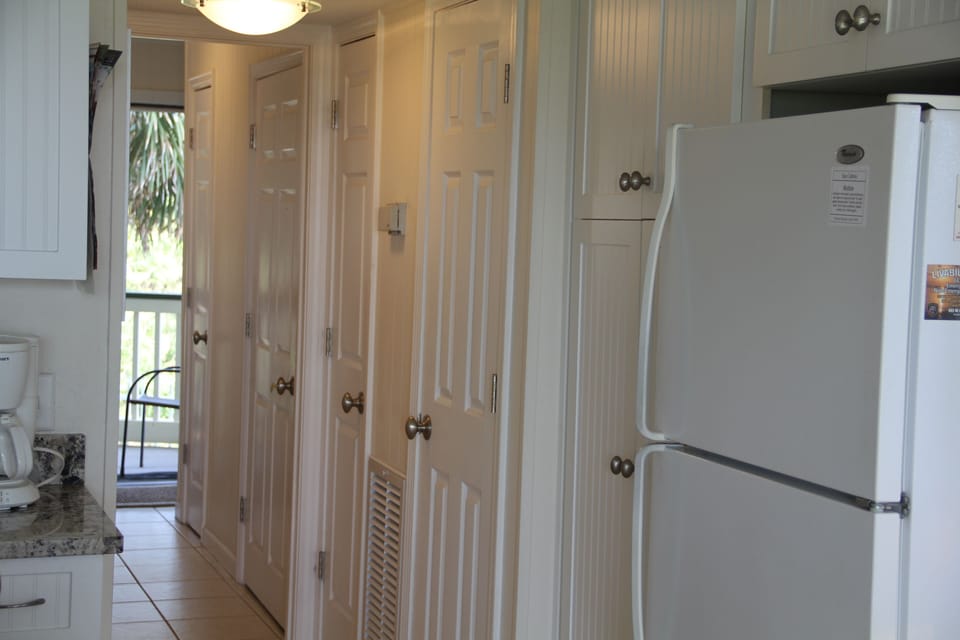Plenty of custom closet storage in tiled hallway