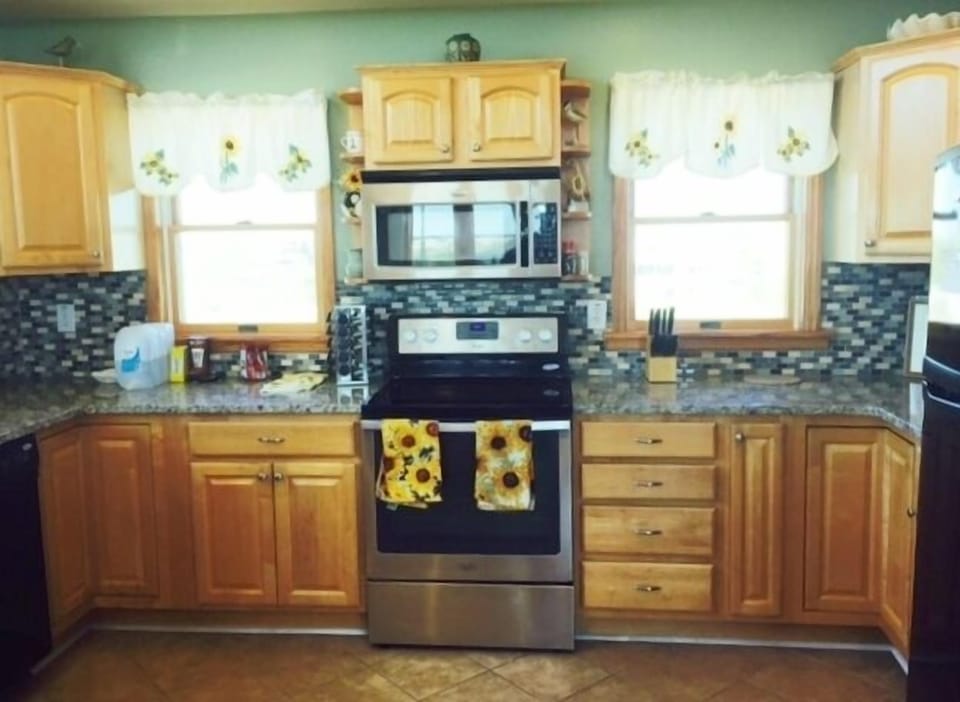 New granite counters and ceramic tile backsplash in   kitchen