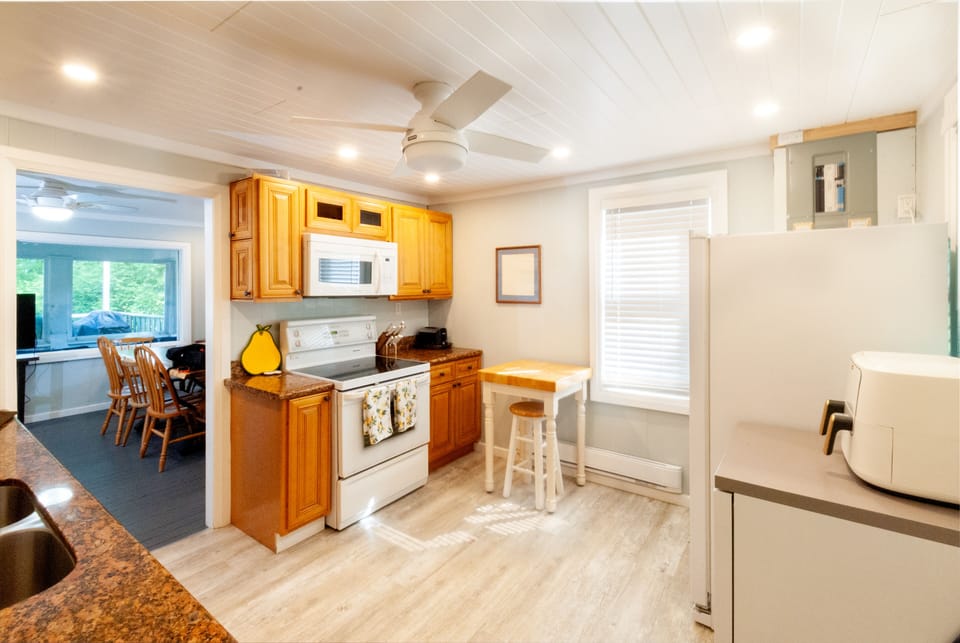 Kitchen showing range, microwave and doorway into living room.