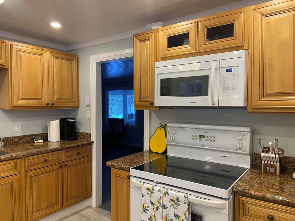 Kitchen showing range and microwave.