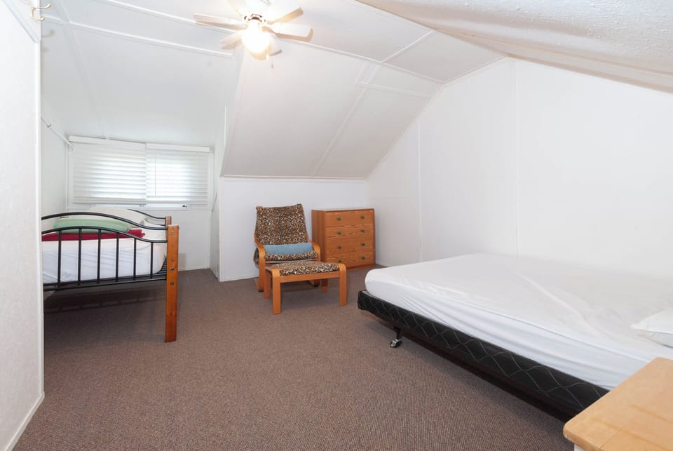 Upstairs east bedroom showing one queen, and one single bed.