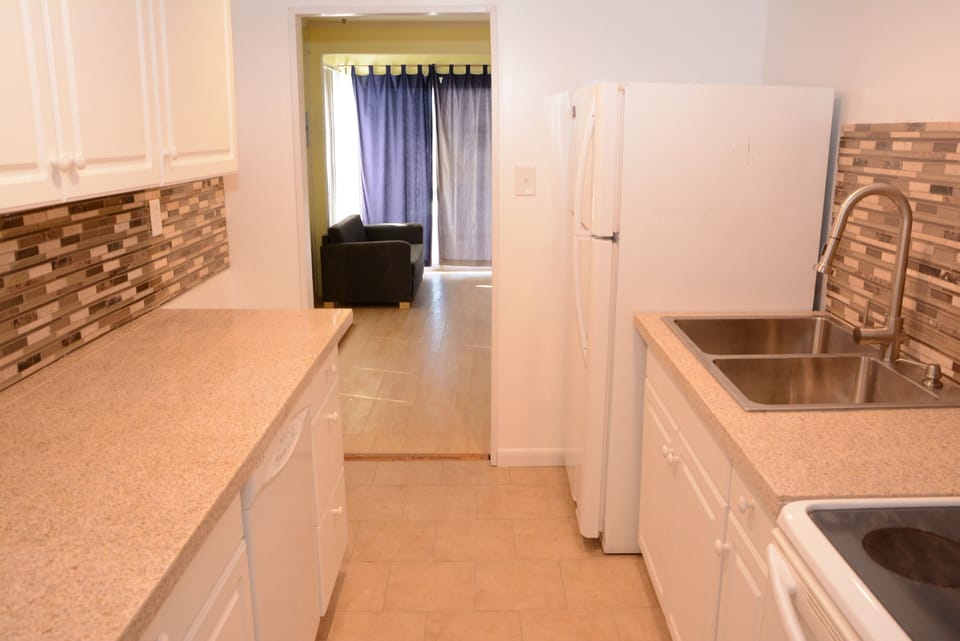 Beautiful kitchen with granite counters, tile floors and LED lighting.
