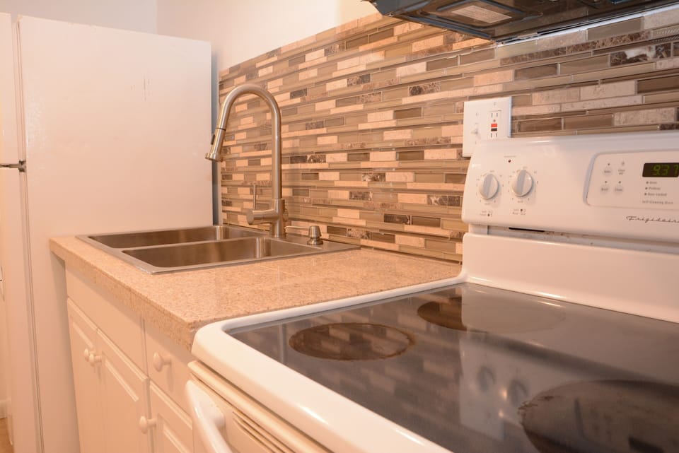 Beautiful kitchen with granite counters, tile floors and LED lighting.