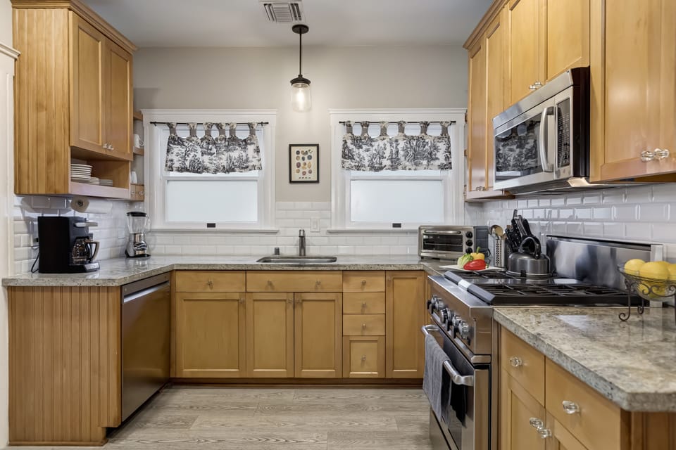 Designer cook's kitchen: granite, subway tile, stainless steel appliances.