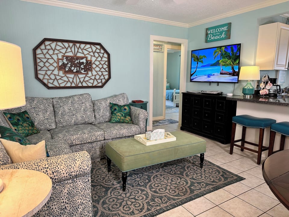Comfy sofas and smart Roku TV in the open concept Living Room.