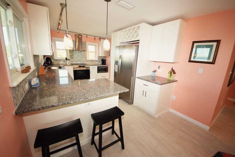 Well equipped kitchen with new stainless appliances and snack bar with bay view
