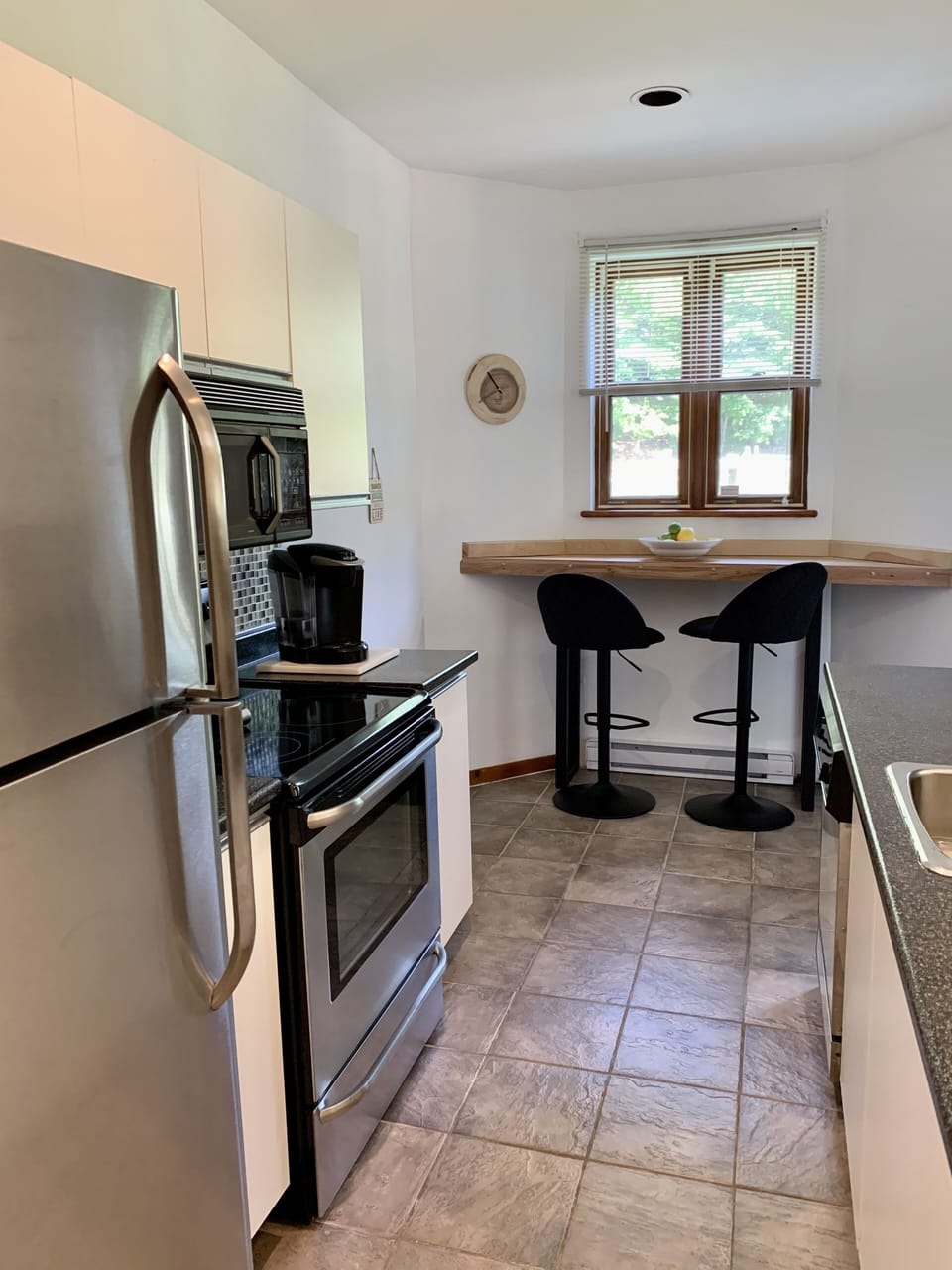 Kitchen view with stainless steel appliances, microwave and dishwasher