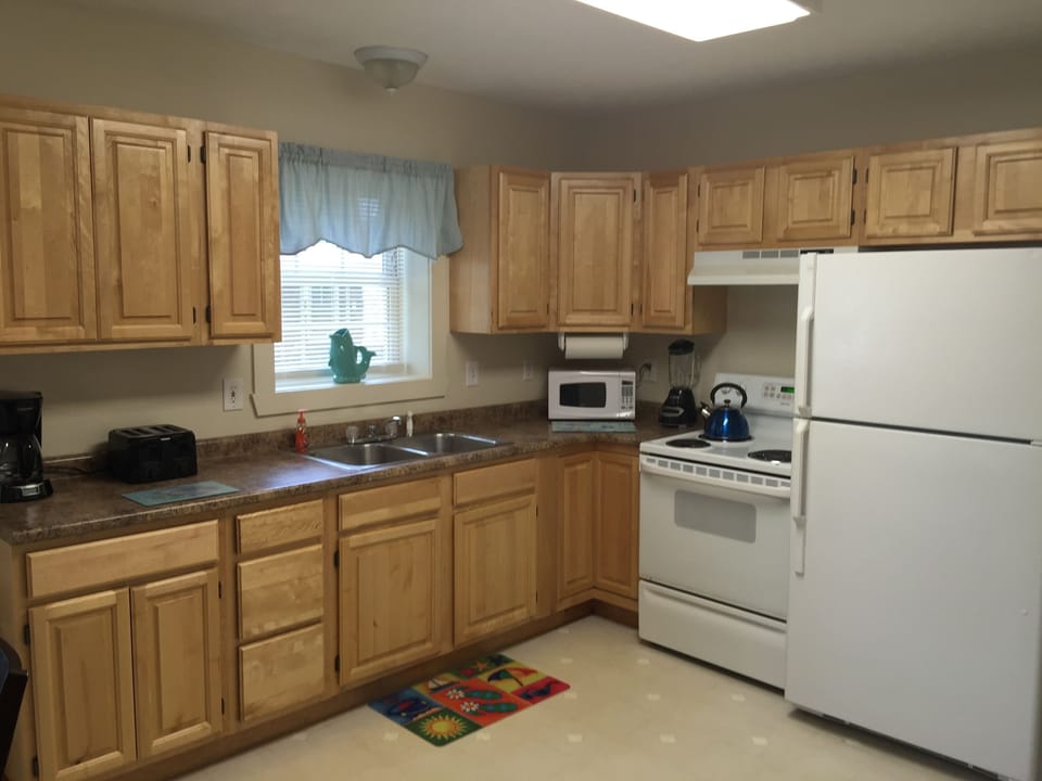 LARGE KITCHEN INCLUDING MICROWAVE, LARGE FRIDGE, STOVE W/OVEN AND FULLY STOCKED 