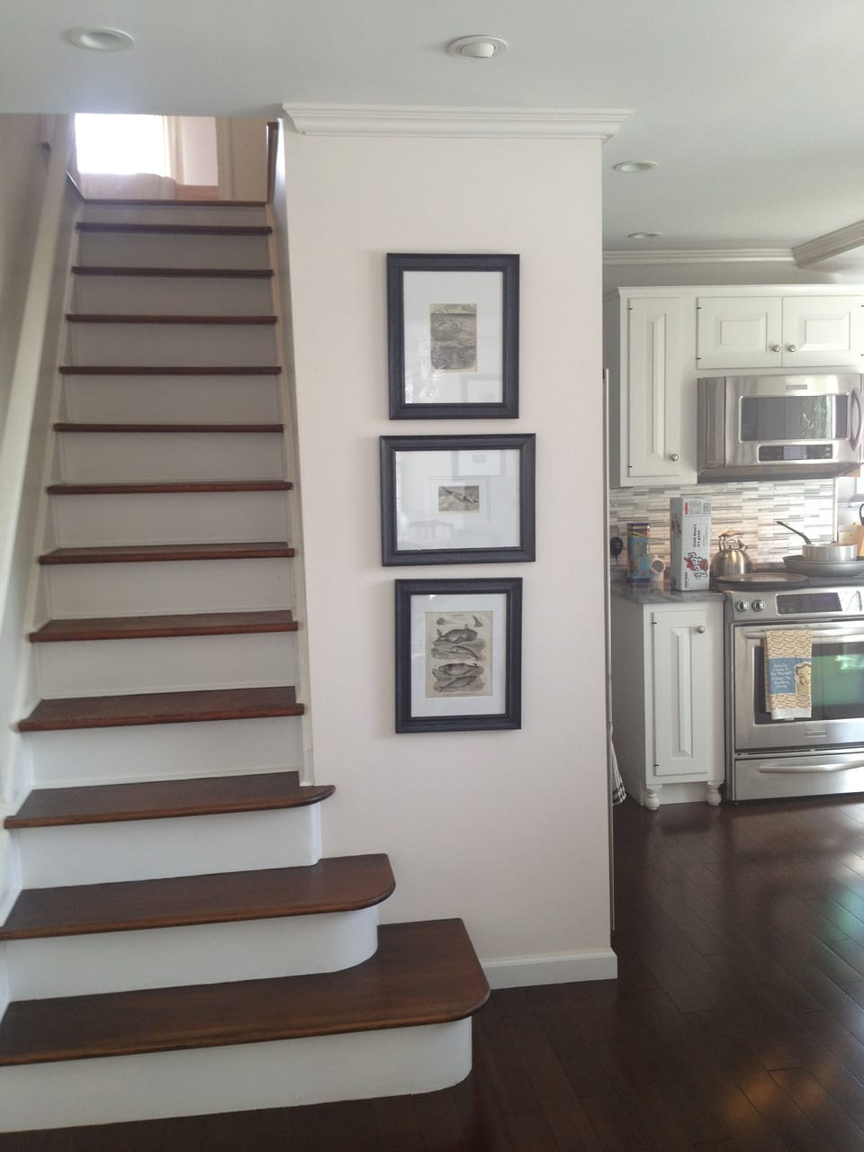 Stairs lead to the second floor from the open concept kitchen / dining room