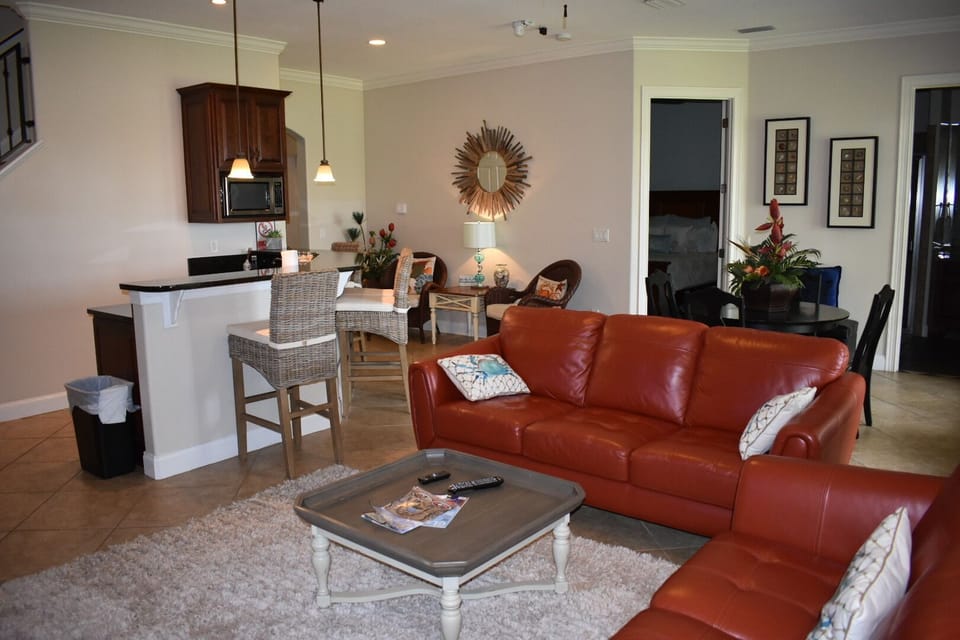 Ground floor family room, couch, love seat, table for 4, +4 at bar top + 2 chair