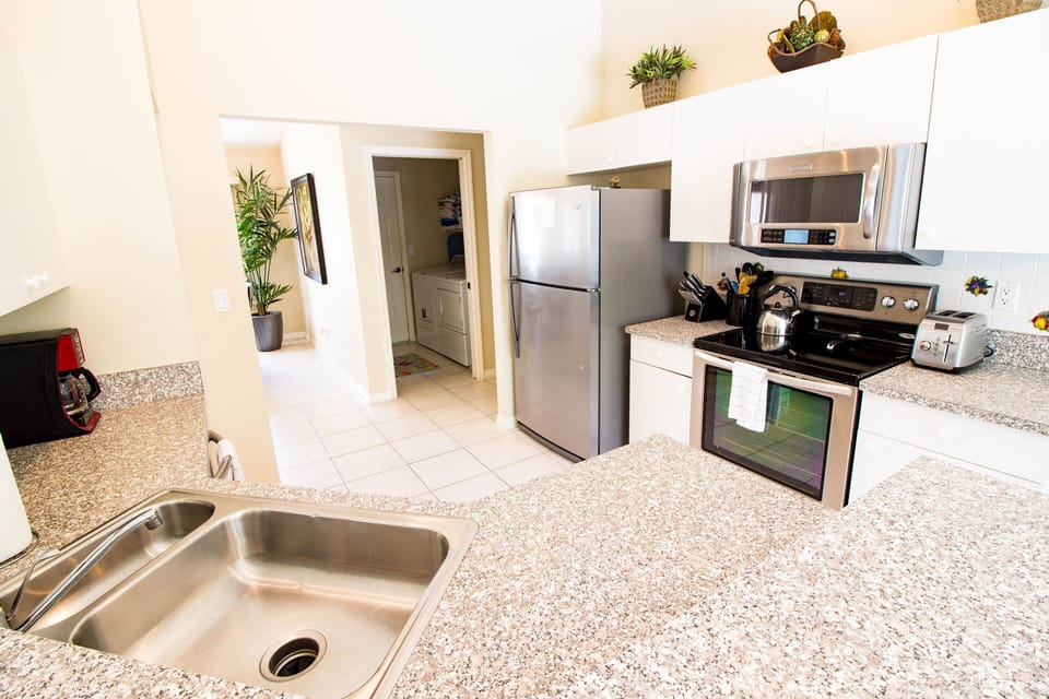 Full-Sized Kitchen with open-floorplan into living-room, main dining, and foyer.  