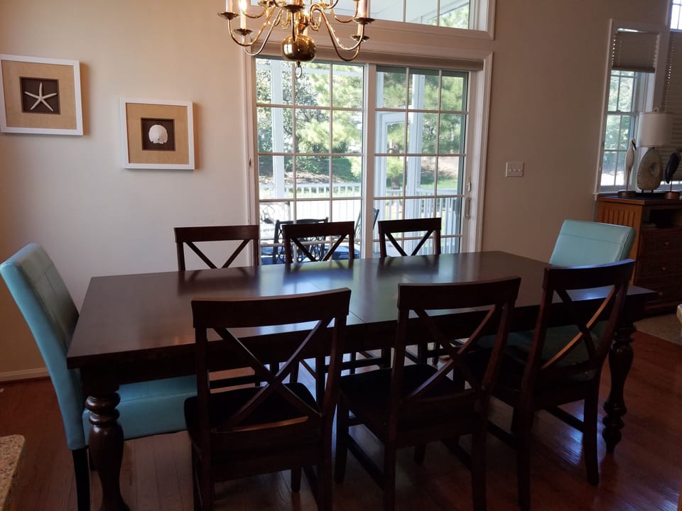 New dining room furniture seats 8 plus 4 at the island. Opens to screen porch.