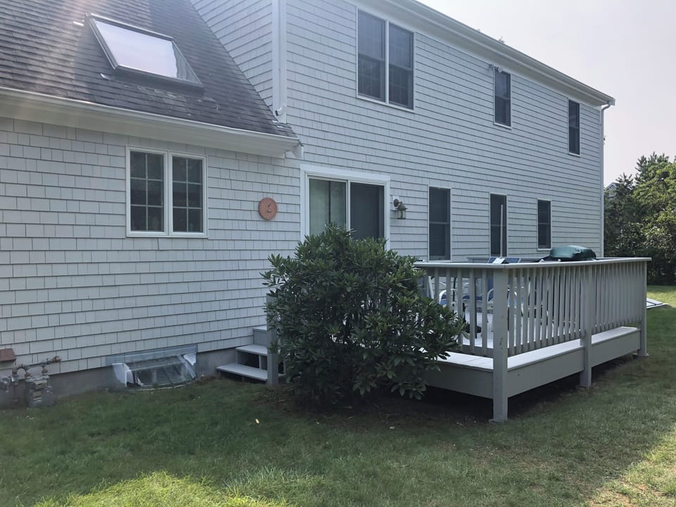 Back deck with table, chairs and small propane grill