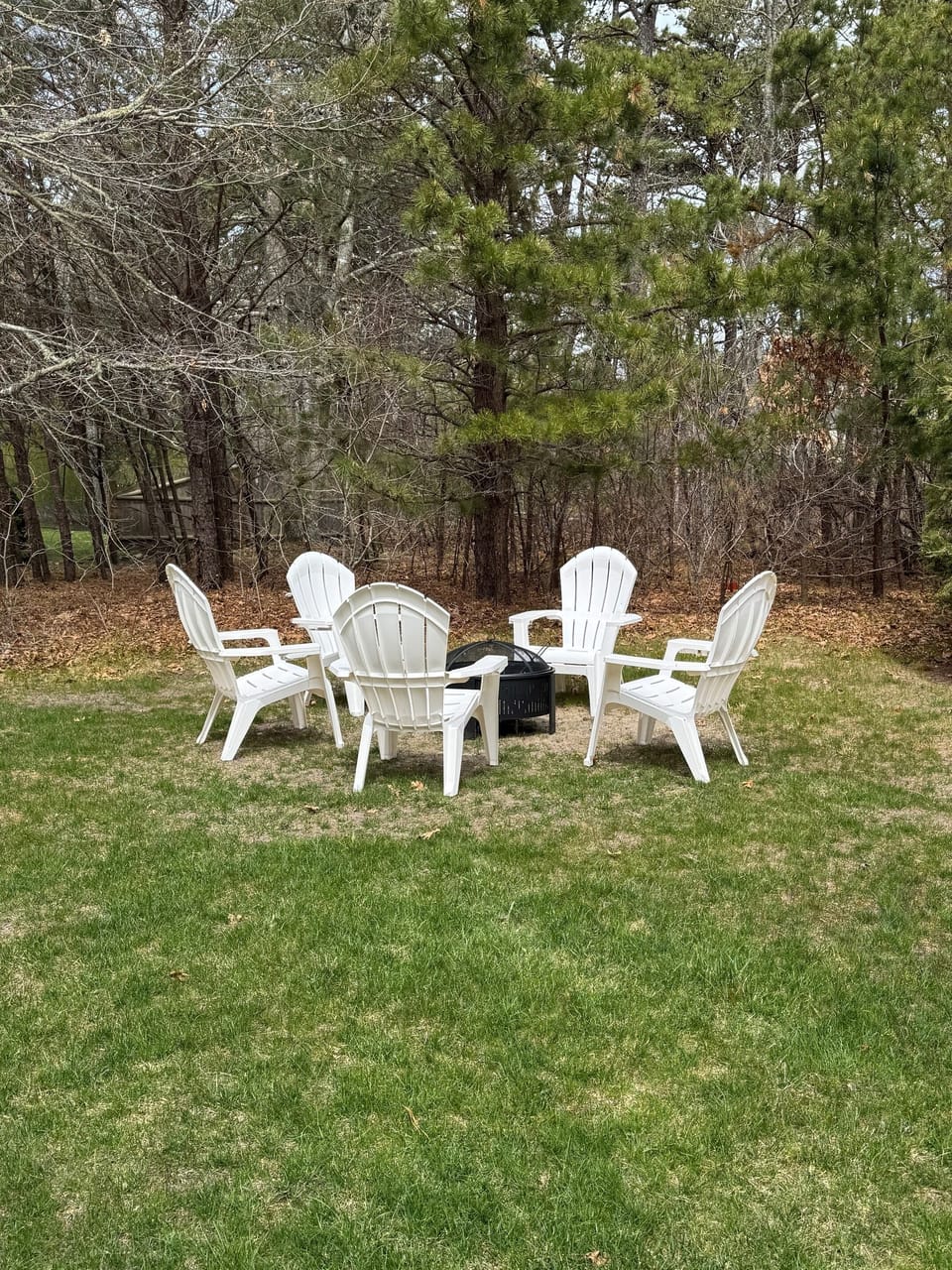 Back-yard fire pit with chairs.