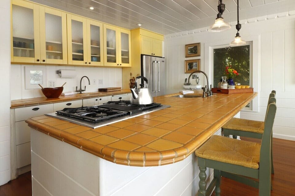 The kitchen is just off the dining room and shares the view. It is fully equipped with all the pots & pans everything else you should need. There is plenty of colorful Fiesta dishes to mix & match and ample silver wear for a lovey place setting. 