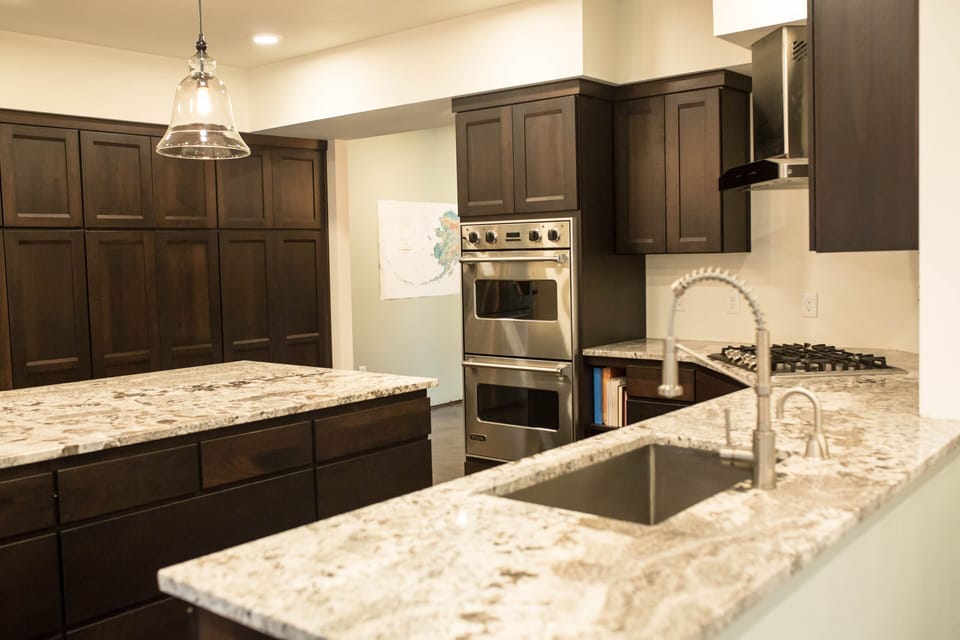 Beautiful granite countertops and a deep stainless steel sink.