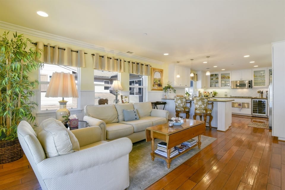 Off the kitchen is this comfortable gathering area that opens to the balcony.