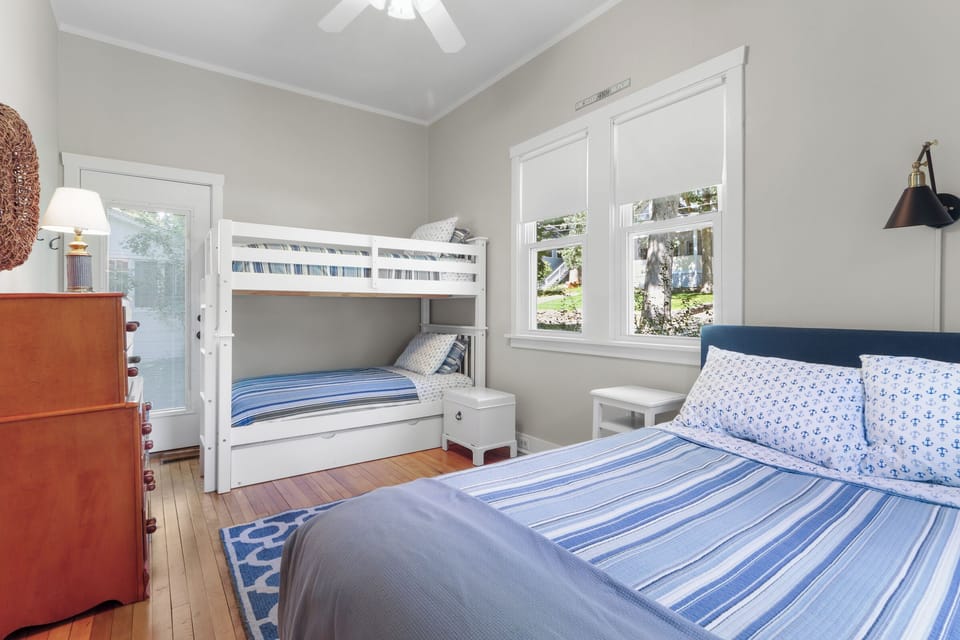 Bedroom 1 with a bunk bed, trundle, and queen bed
