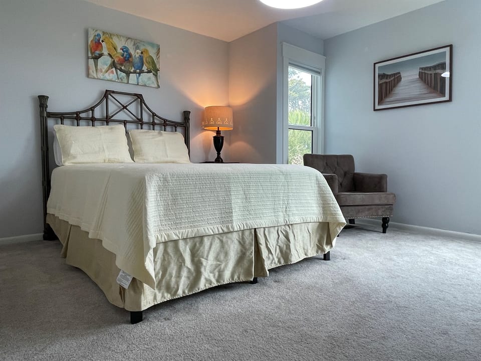 One of two main floor guest rooms, each featuring a queen bed, and ocean view. 