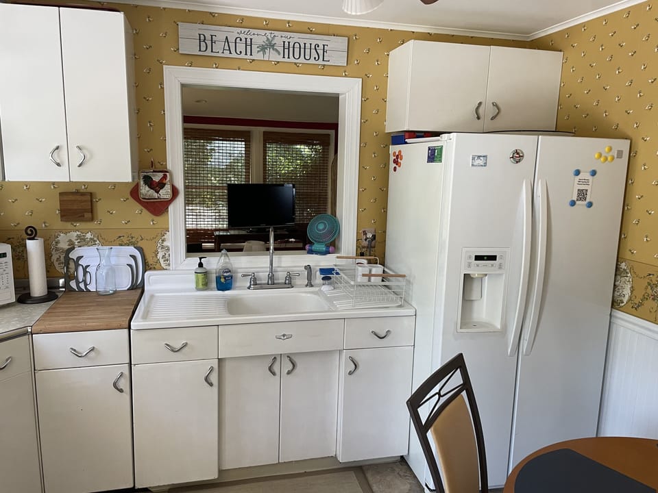Kitchen with an open window to the sun room.