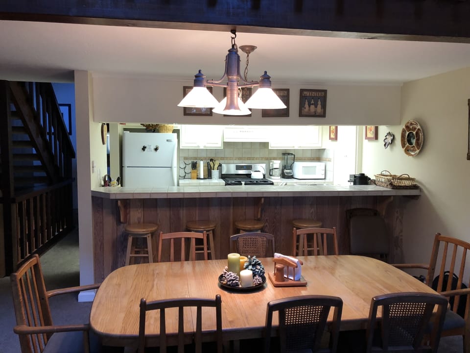 Dining table seats 8 adults alongside well appointed kitchen. 