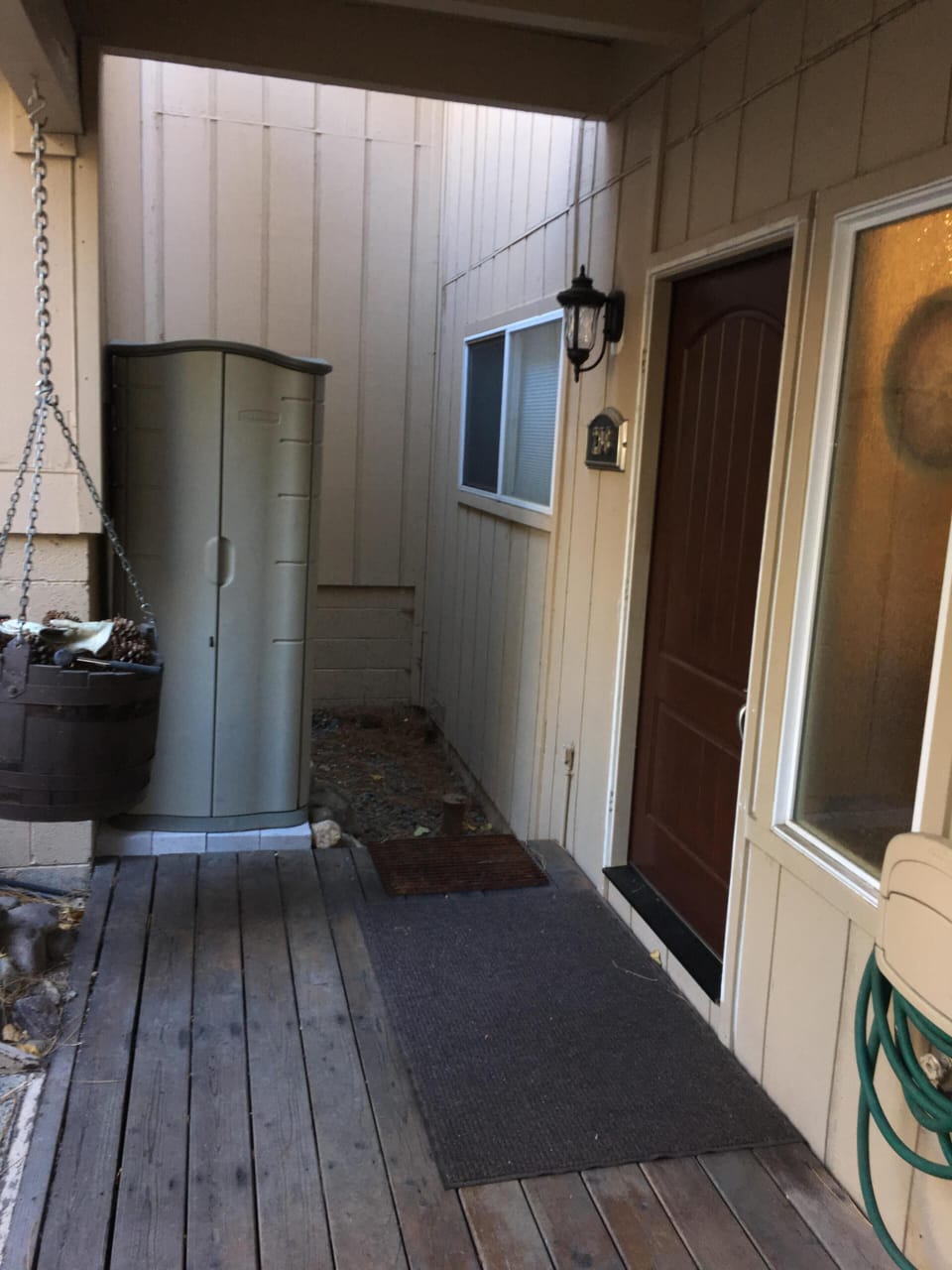 Covered entryway with a lockable ski locker to stow skis and snowboards. 