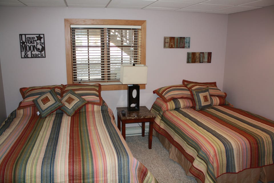 Lower unit bedroom with one queen and one double bed
