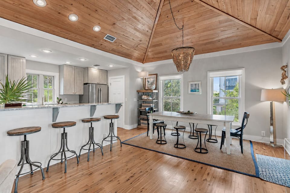 Quartzite counters bartop seating, dining table, open vaulted entertainment area
