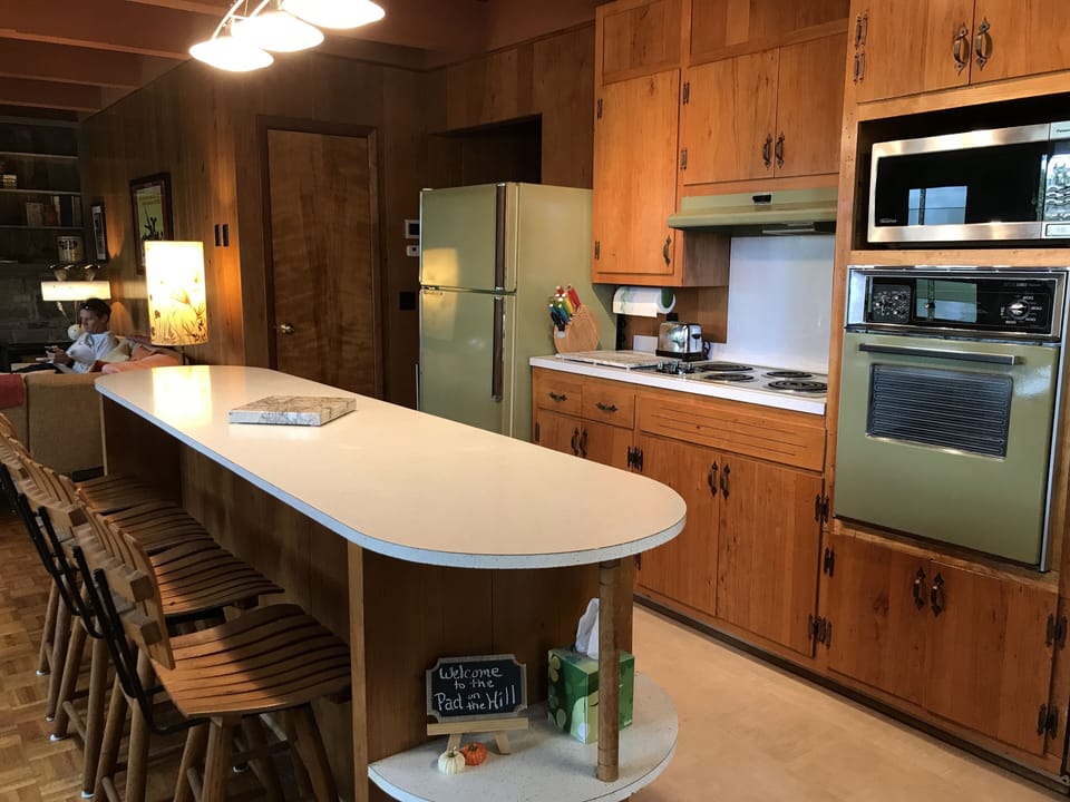 Original 1962 kitchen stocked for cooking and dining 