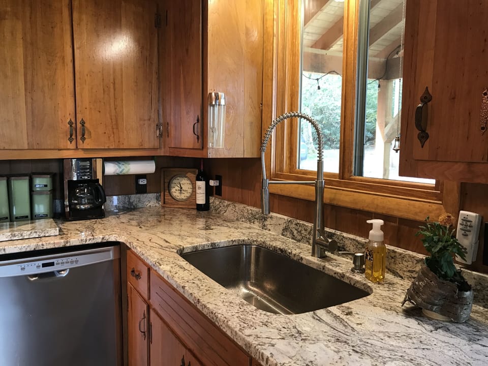 Sleek new sink, faucet and dishwasher, coffee pot and whole bean grinder