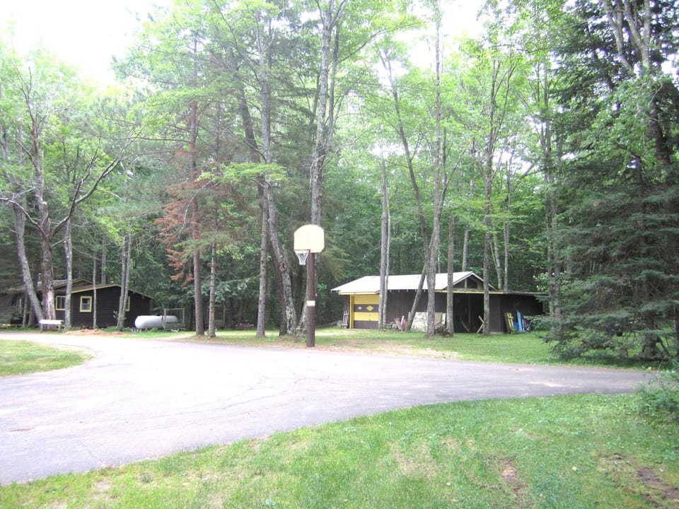 Driveway with basketball hoop and open area