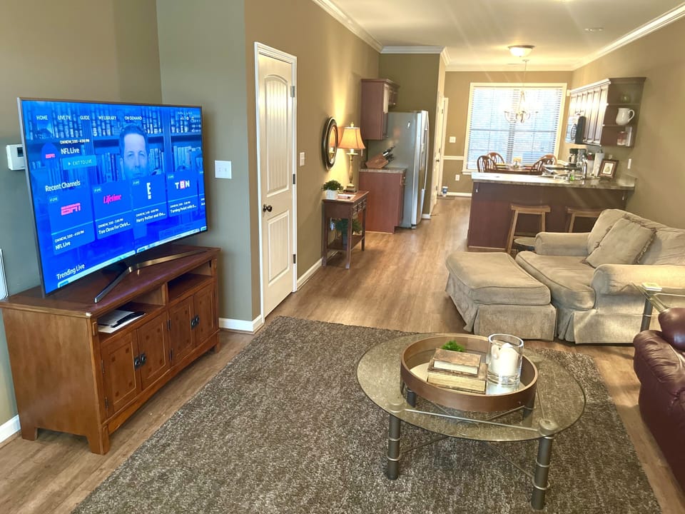 Comfortable living area with ample couch, love seat, and double chair.