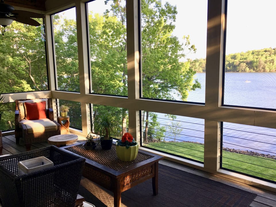 Relaxing screened porch with ceiling fans
