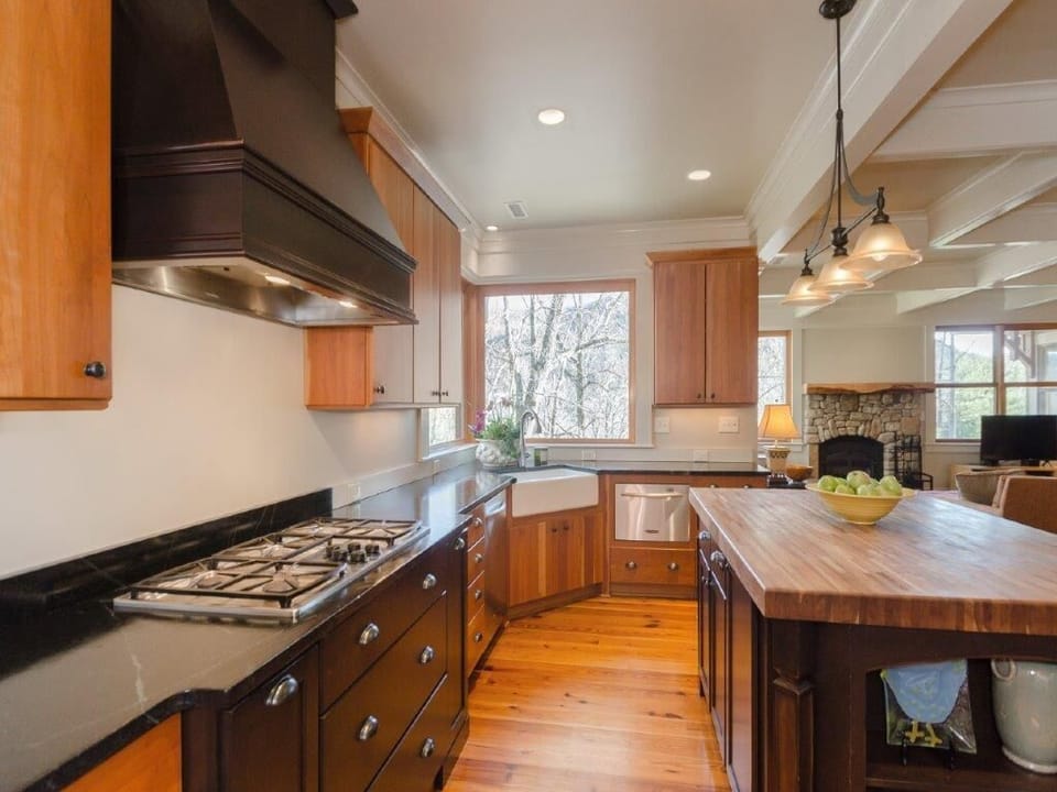 The kitchen has two refrigerators, dishwashers and ovens and plenty of dishes.