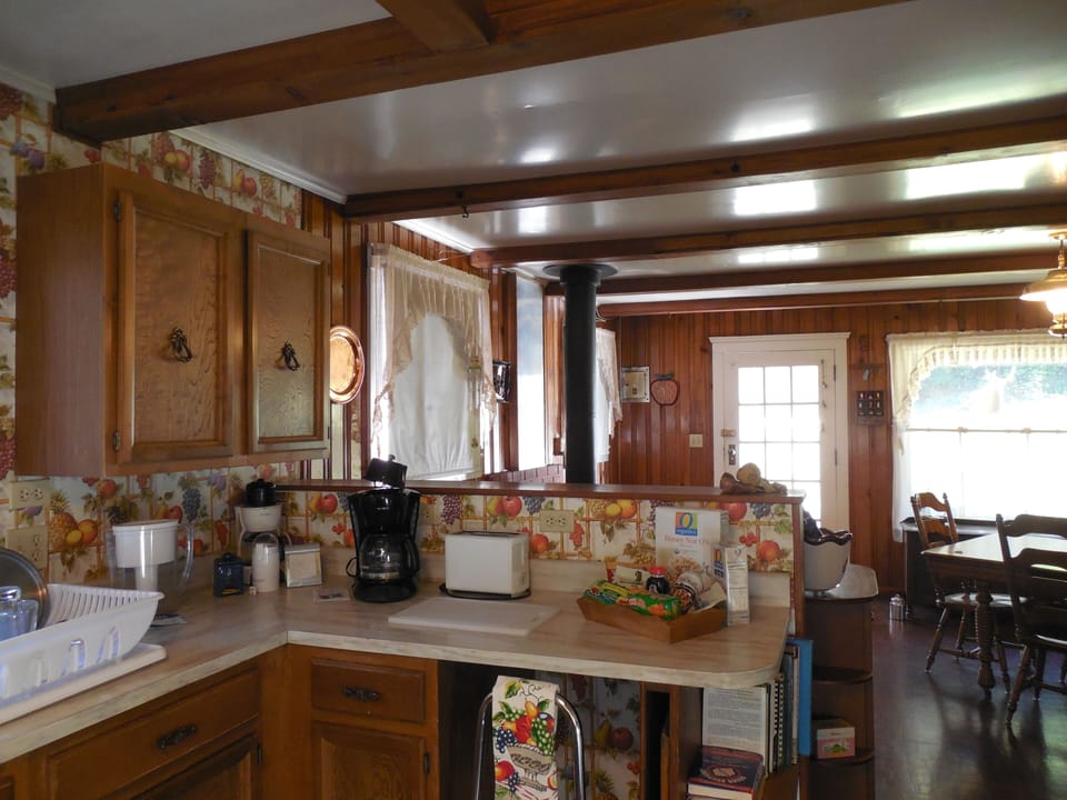 Kitchen into dining room and the entry door to the home.