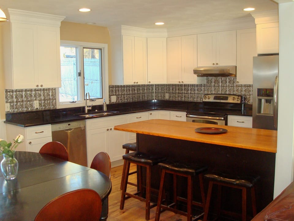 Modern bright kitchen.  Breakfast bar seats 4. Dining table seats 6.  