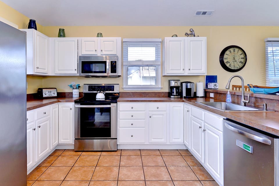 Kitchen with stainless appliances.  Very well stocked with all you need.