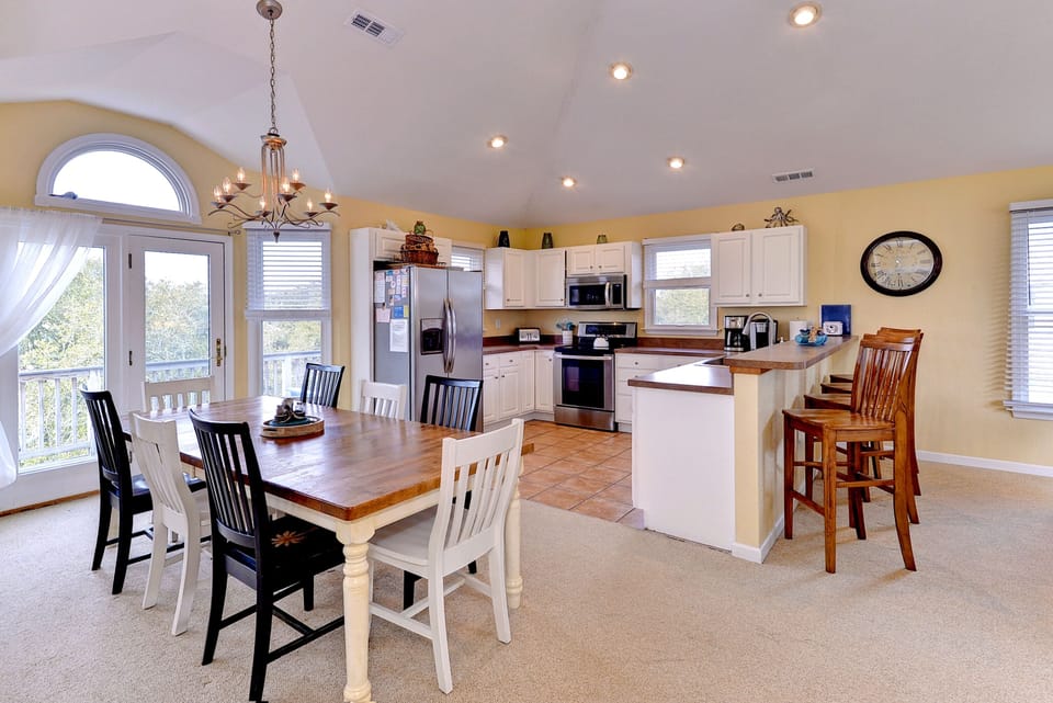 Oversized table to easily fit 8-10.  Countertop bar chairs add 4 more seats.